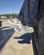 New Balance 2002R Protection Pack Rain Cloud portée contre un mur